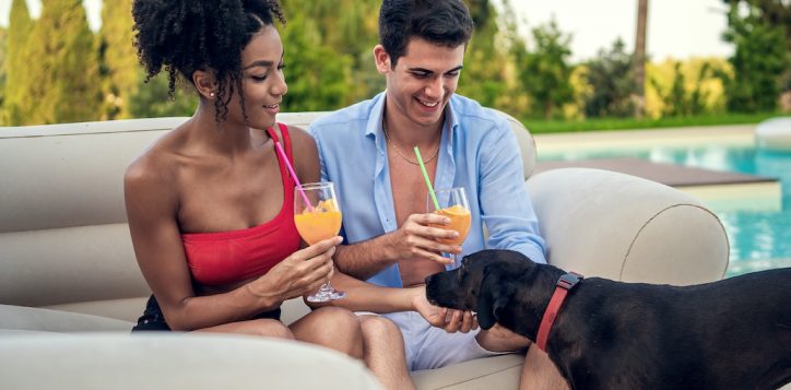 interracial-couple-relaxes-with-their-pet-in-a-luxury-villa-or-resort-2